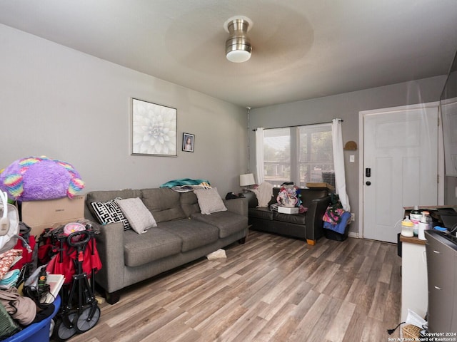 living room featuring hardwood / wood-style floors and ceiling fan