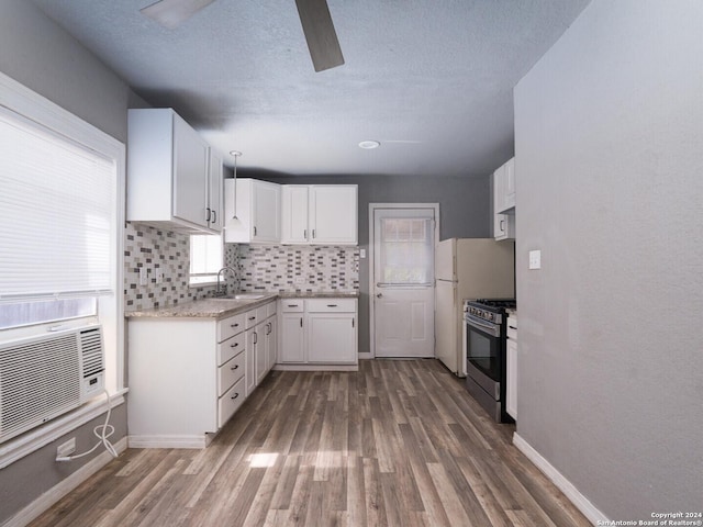 kitchen with white cabinetry, gas stove, dark hardwood / wood-style floors, and sink