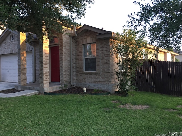 view of front facade with a garage and a front lawn