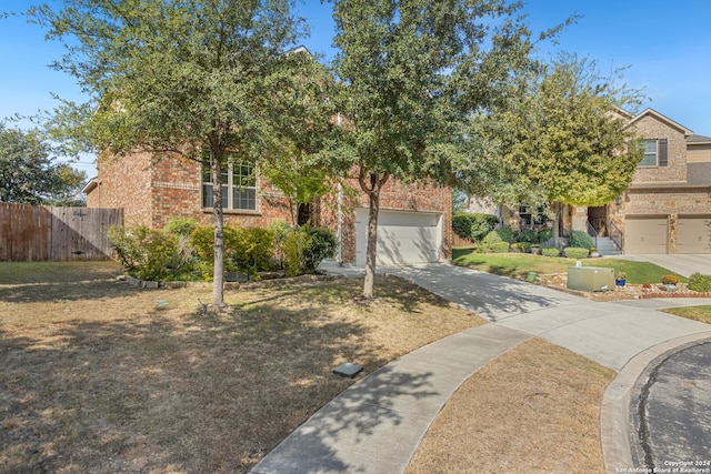 view of property hidden behind natural elements with a garage