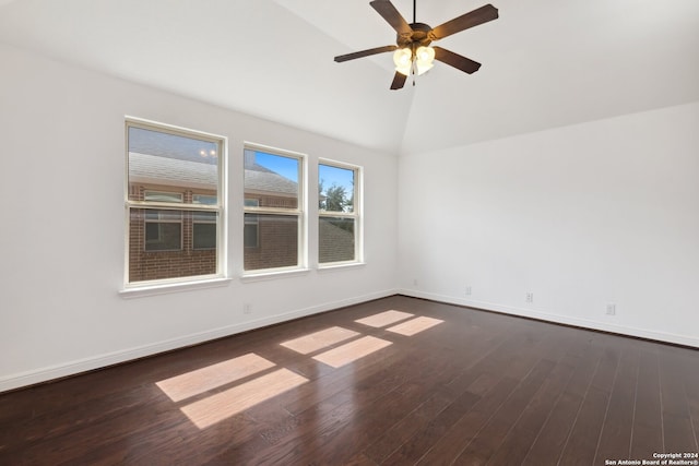 empty room featuring ceiling fan, lofted ceiling, and dark hardwood / wood-style floors