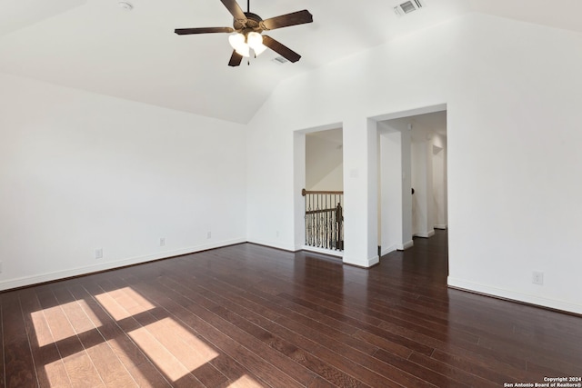 empty room with ceiling fan, dark hardwood / wood-style floors, and vaulted ceiling