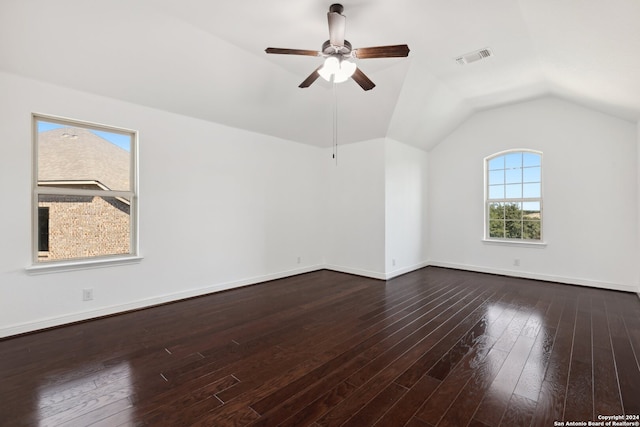 interior space featuring ceiling fan, dark wood-type flooring, and vaulted ceiling