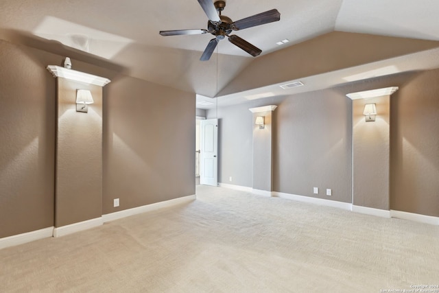 unfurnished room featuring lofted ceiling, ceiling fan, and light carpet