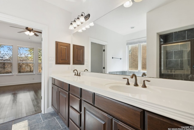 bathroom with wood-type flooring, vanity, and ceiling fan