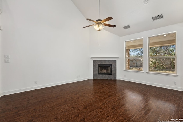 unfurnished living room featuring a fireplace, ceiling fan, dark wood-type flooring, and vaulted ceiling