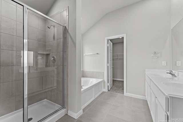 bathroom with tile patterned flooring, vanity, independent shower and bath, and vaulted ceiling