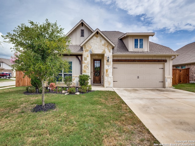 view of front of property featuring a garage and a front lawn