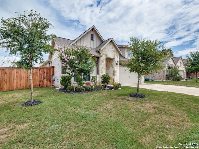 view of front of home with a garage and a front lawn