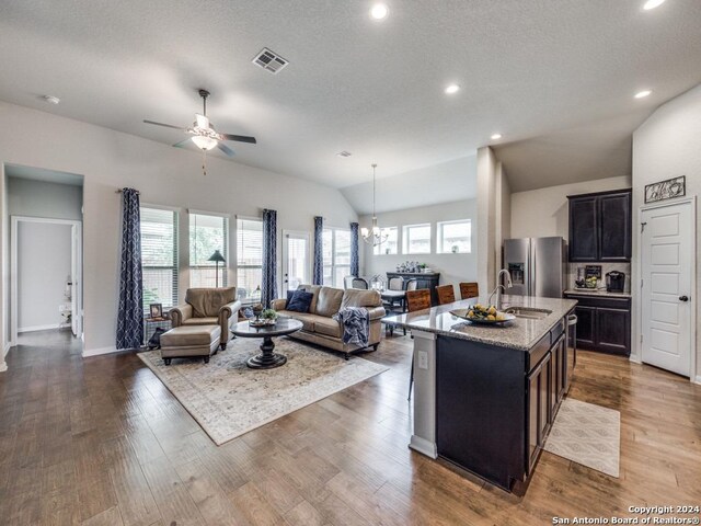 kitchen featuring appliances with stainless steel finishes, a kitchen island with sink, and sink