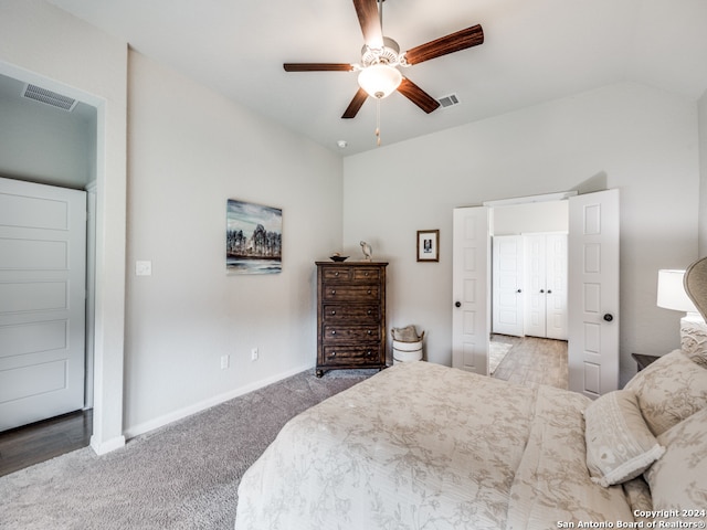 carpeted bedroom featuring ceiling fan and lofted ceiling