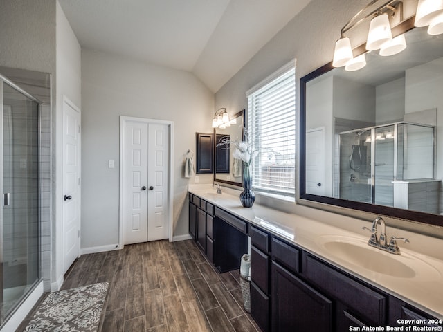 bathroom featuring vanity, lofted ceiling, and walk in shower