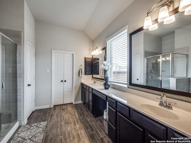 bathroom with separate shower and tub, vanity, and lofted ceiling