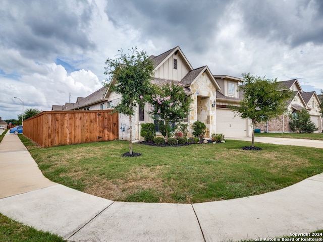 view of front of home featuring a front yard and a garage