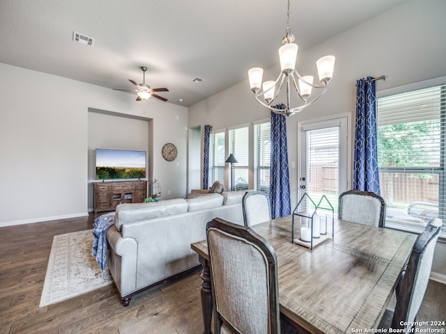 dining area with ceiling fan with notable chandelier and dark wood-type flooring