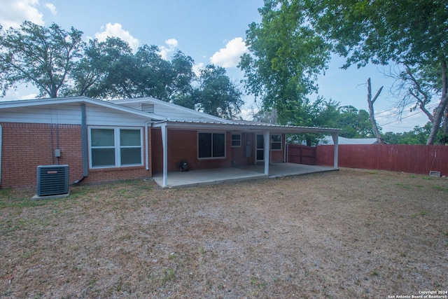 rear view of house with central air condition unit