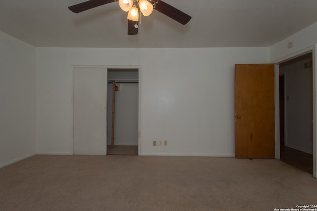 unfurnished bedroom featuring a closet, carpet floors, and ceiling fan