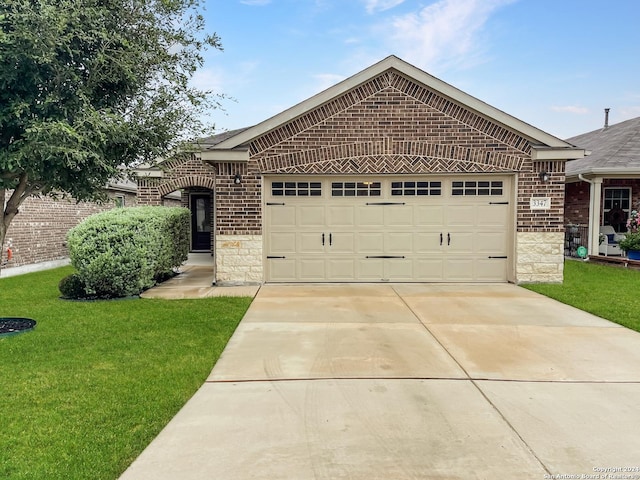 ranch-style home featuring a garage and a front yard