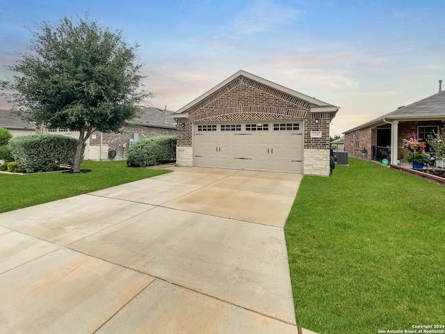 view of front of home featuring central AC unit and a lawn