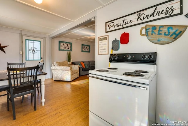 kitchen with open floor plan, electric range, and light wood-style floors