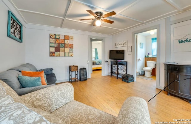 living room with light wood-style floors, baseboards, coffered ceiling, and a ceiling fan