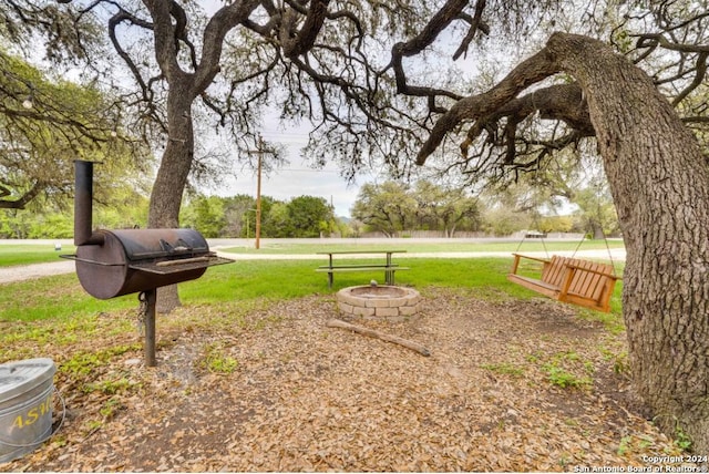 view of yard with an outdoor fire pit