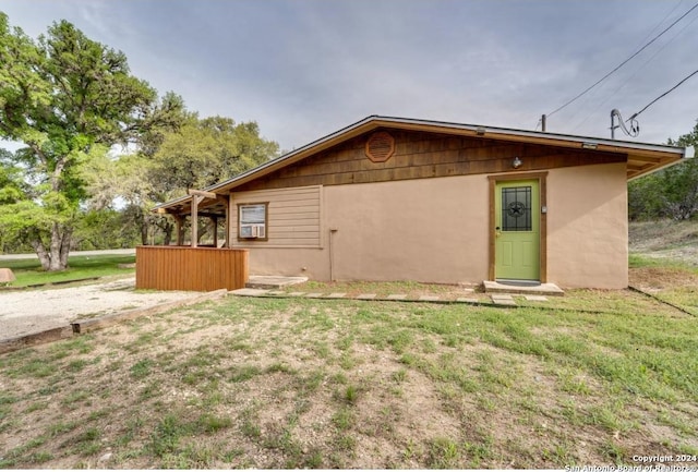 exterior space featuring a lawn and stucco siding