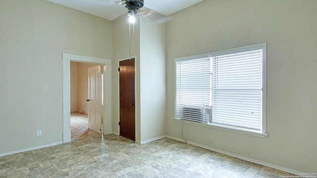 unfurnished bedroom featuring light tile patterned flooring, multiple windows, and ceiling fan