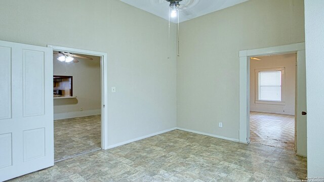 empty room featuring ceiling fan and tile patterned floors