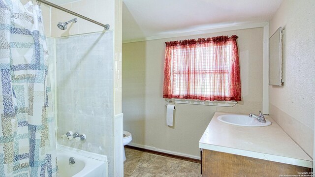 full bathroom featuring tile patterned flooring, shower / bath combo, toilet, and vanity