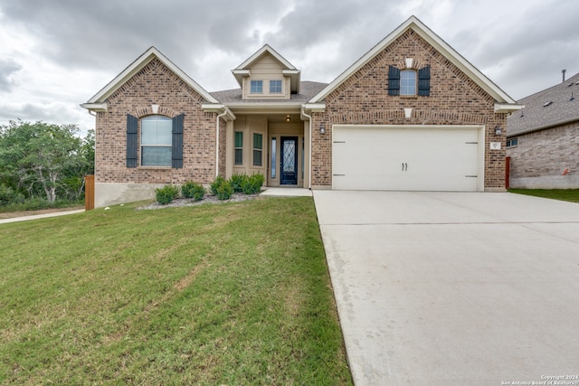 view of property with a garage and a front lawn