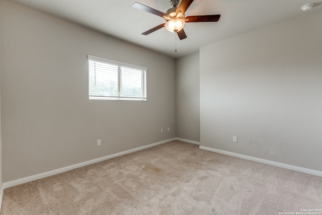 unfurnished room with ceiling fan and light colored carpet