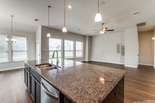 kitchen featuring sink, stainless steel dishwasher, a wealth of natural light, and dark wood-type flooring