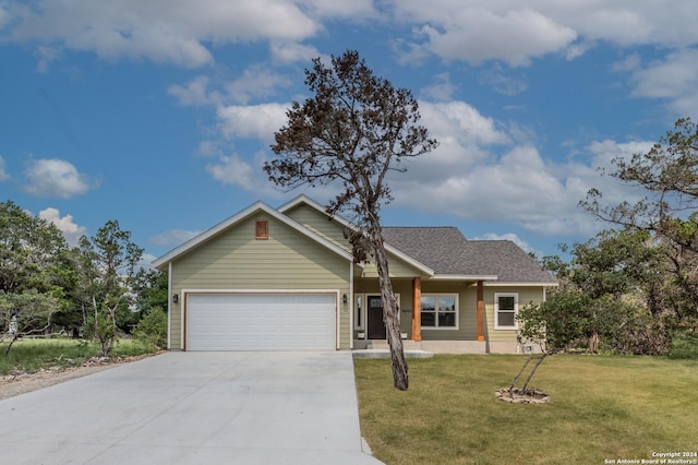 ranch-style home featuring a garage and a front lawn