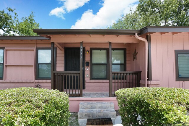 view of exterior entry with covered porch