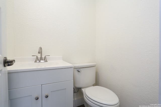 bathroom with toilet and vanity