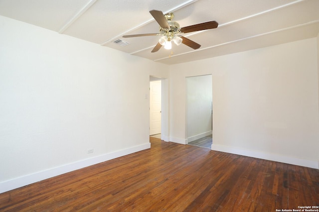 empty room with ceiling fan and dark hardwood / wood-style flooring