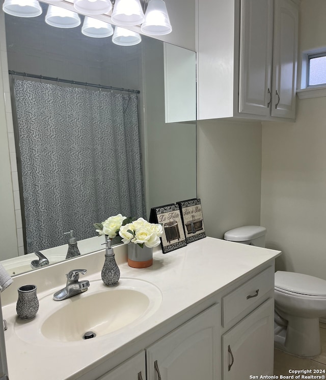 bathroom featuring toilet, vanity, a shower with shower curtain, and tile patterned flooring