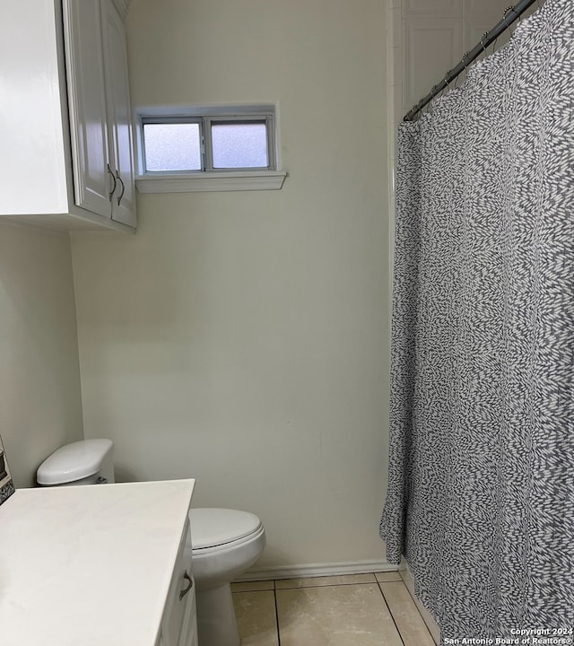 bathroom with vanity, toilet, and tile patterned flooring