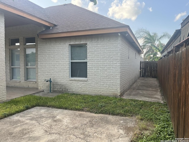 view of side of home with a patio