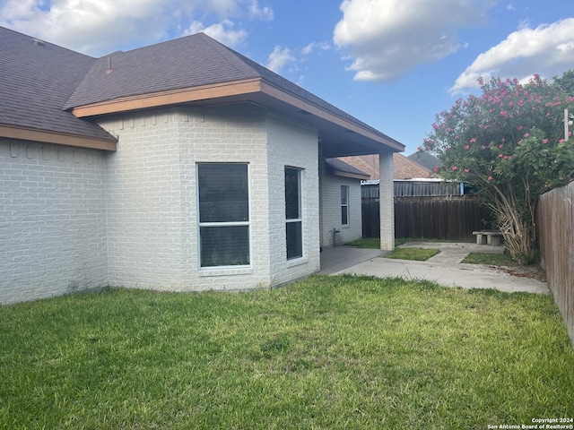 back of property featuring a patio and a lawn