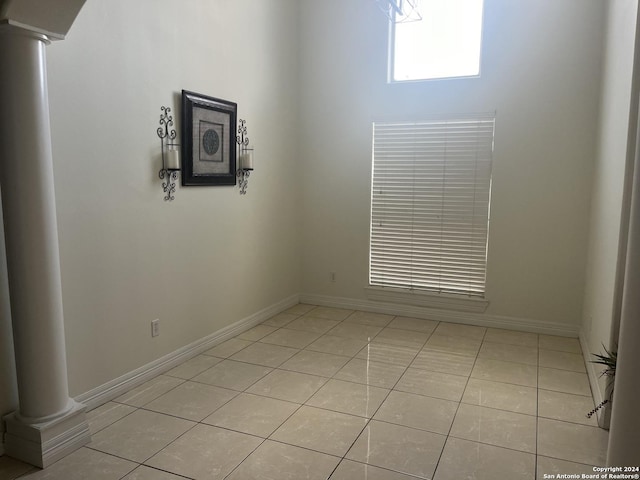 tiled spare room with ornate columns