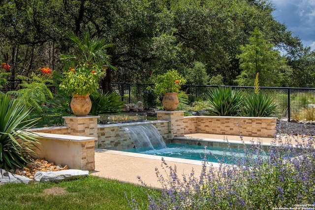 view of pool with pool water feature