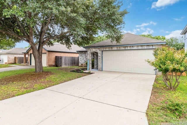 single story home featuring a garage and a front lawn