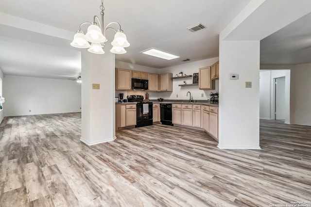 kitchen with light brown cabinetry, hanging light fixtures, ceiling fan, hardwood / wood-style floors, and black appliances