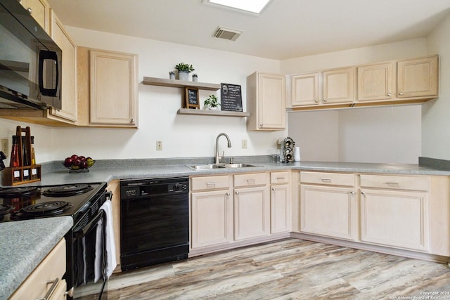 kitchen with light hardwood / wood-style floors, sink, and black appliances