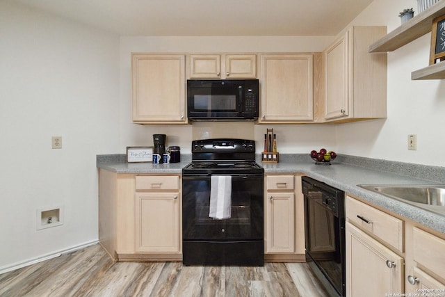 kitchen featuring light wood-type flooring, light brown cabinets, and black appliances