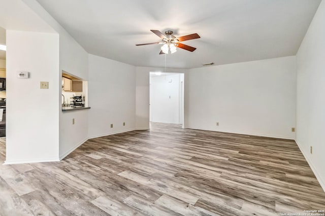 unfurnished living room with hardwood / wood-style floors and ceiling fan