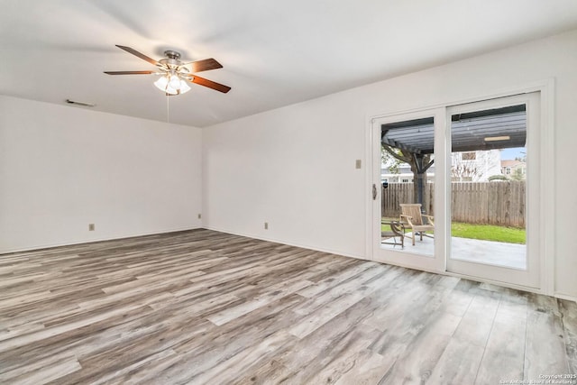 empty room with light hardwood / wood-style flooring and ceiling fan