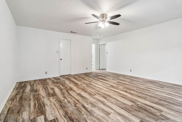 empty room featuring light hardwood / wood-style flooring and ceiling fan